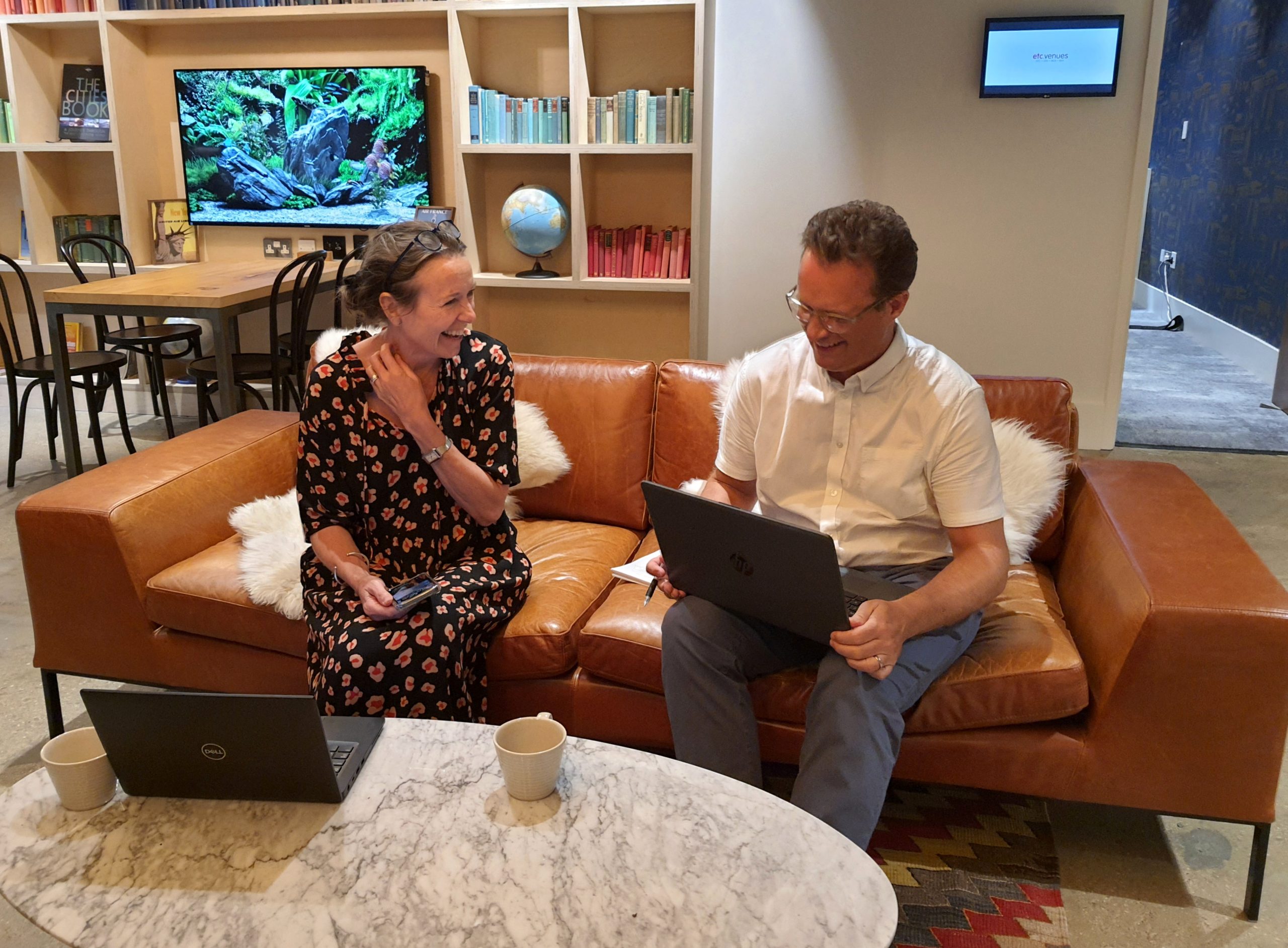 Jane and David working on an office sofa - PCR Technology Recruitment